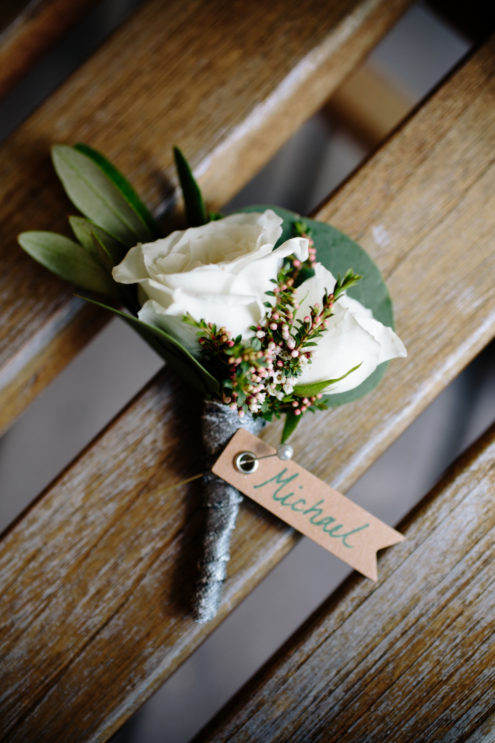 A white rose groom's boutineer.
