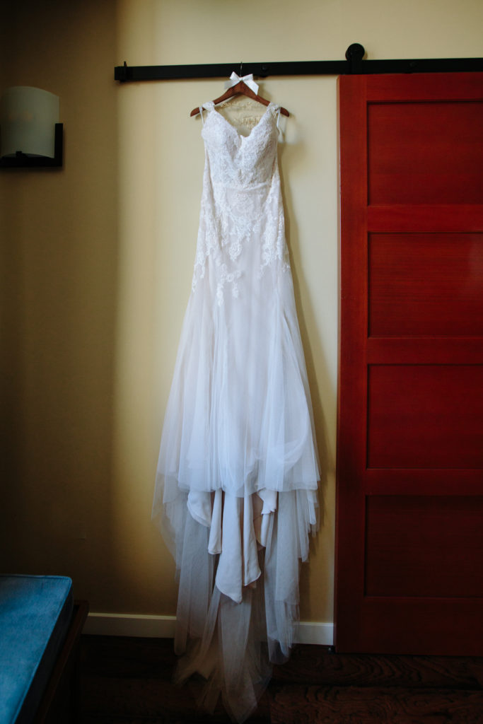 Wedding gown hanging in the dressing room.