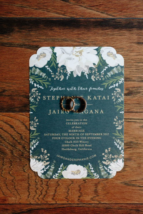 Wedding invitation and wedding rings.