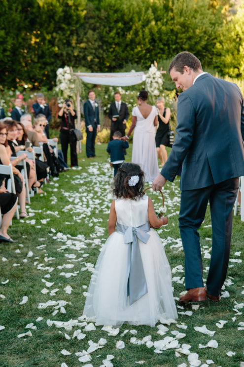 Flower girl walks down the aisle at Solage.