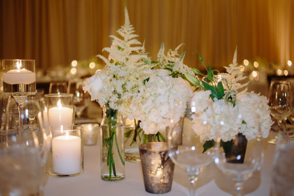 White and grey wedding reception flowers at Solage.