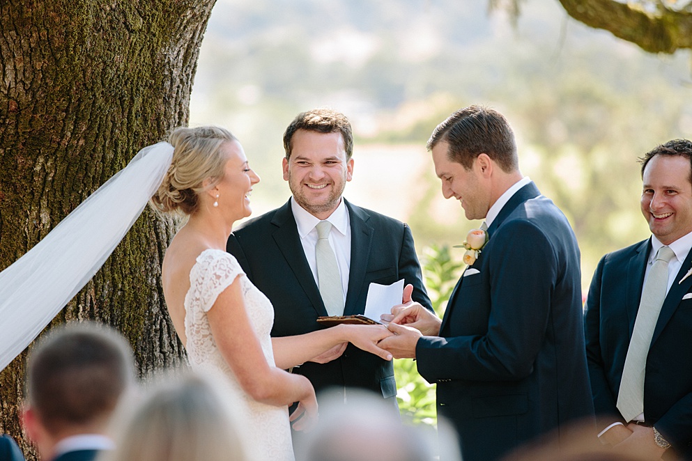 bride laughs at grooms vows during Beltane Ranch wedding