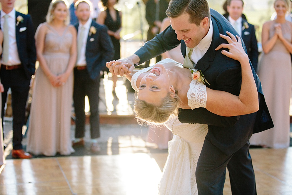 Groom dips the bride in dance at Beltane Ranch wedding by michelle walker photography