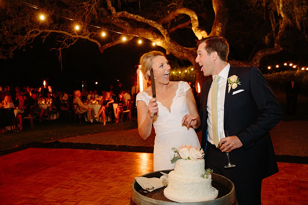 bride and groom being cheesy before cutting the cake at Beltane Ranch wedding by michelle walker photography