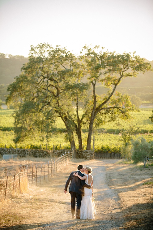 bride and groom kiss at Beltane Ranch wedding outside of reception by michelle walker photography