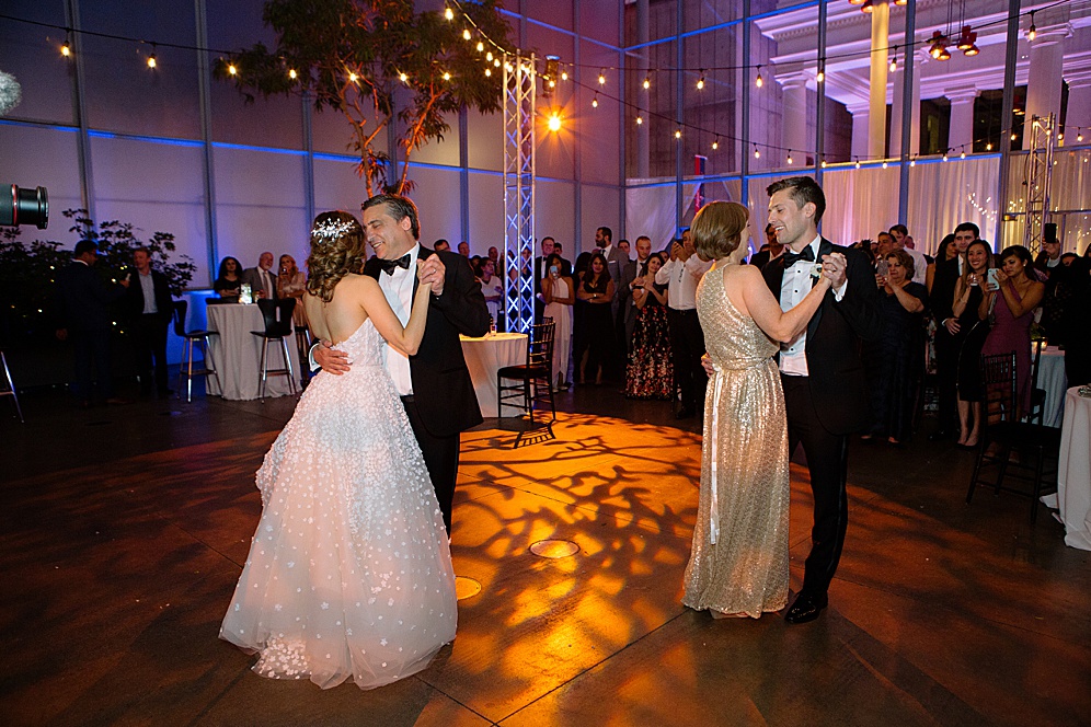 bride and groom dance with their parents at California Academy of Sciences Wedding