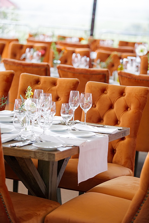 orange table setting for a wedding by michelle walker photography