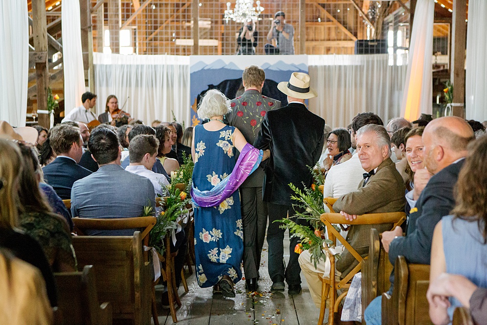 groom walking down the aisle at a barn wedding by michelle walker photography