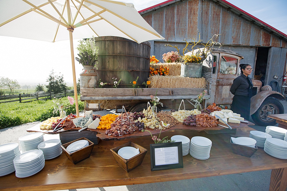 barn reception area with cheese at Five Springs Ranch wedding by michelle walker photography