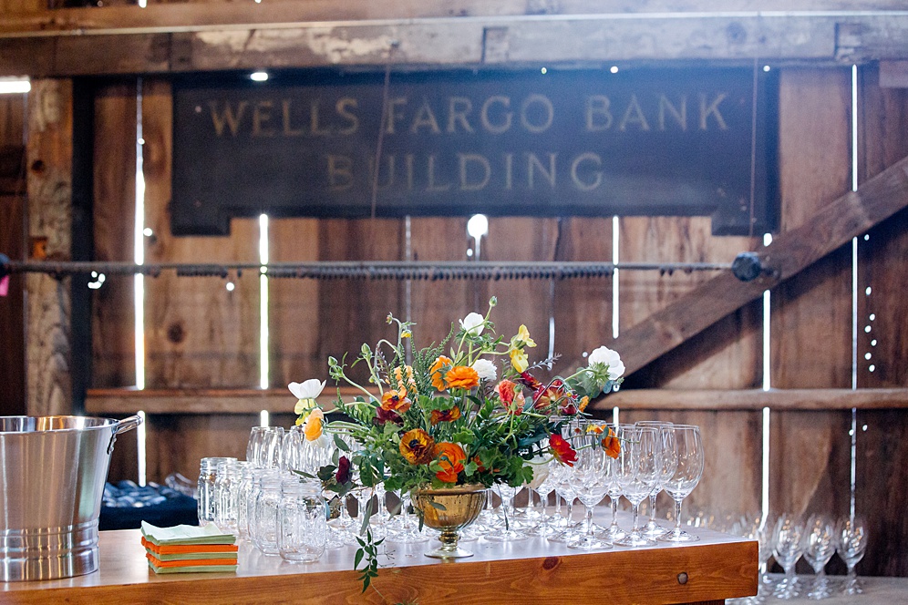 barn reception area with flowers at Five Springs Ranch wedding by michelle walker photography