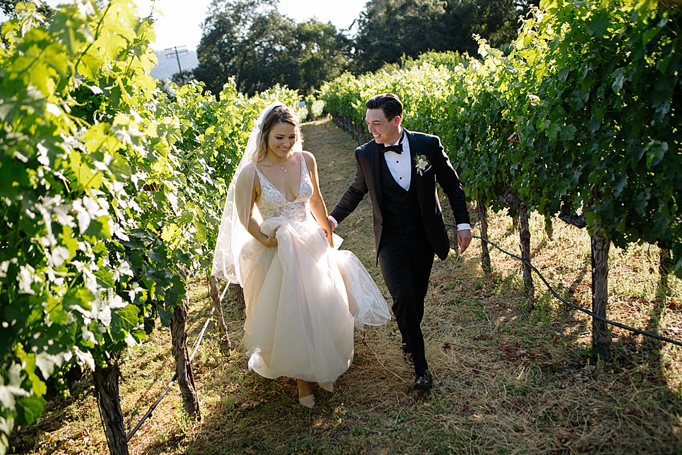 bride and groom in vineyards at calistoga ranch wedding by michelle walker photography