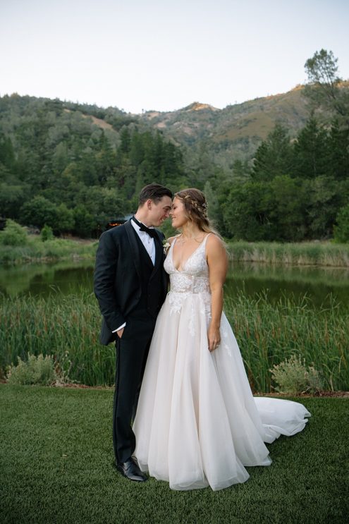 bride and groom nuzzle foreheads at calistoga ranch wedding by michelle walker photography