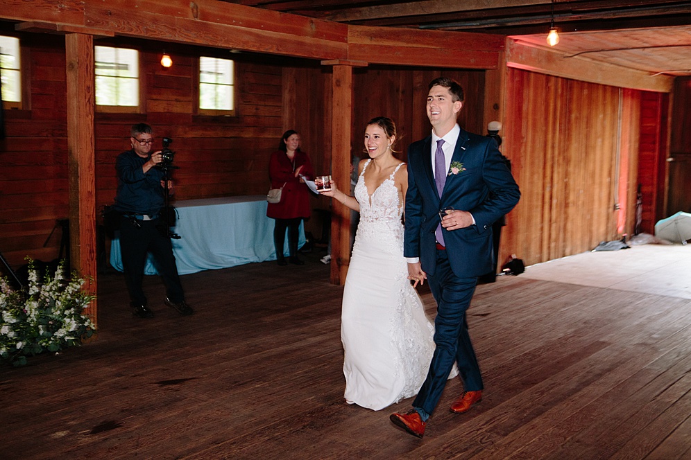 bride and groom walk into reception at Campovida winery wedding