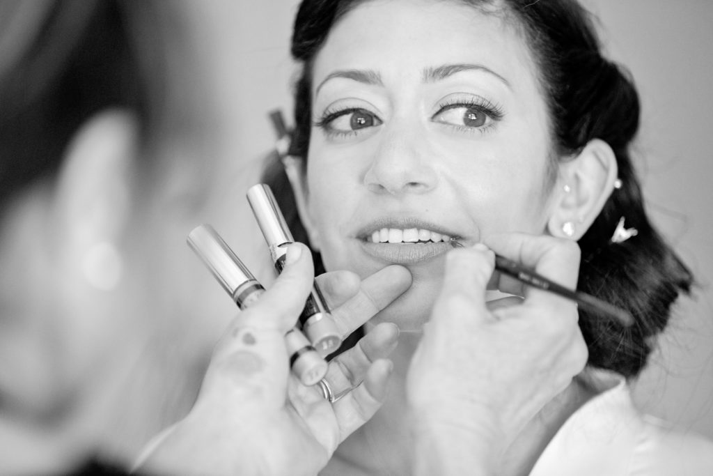 Bride getting makeup done for her wedding.