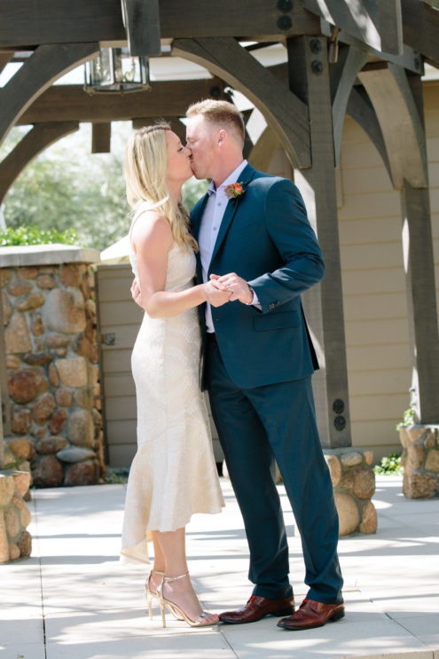 Bride and groom's first kiss as their intimate wedding ceremony in Napa.