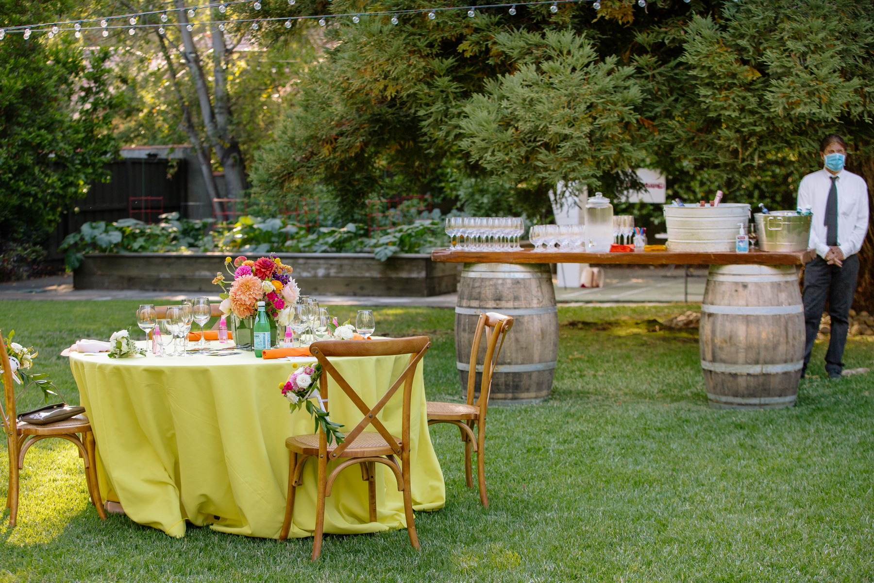 lemon yellow linens and colorful flowers at this backyard wedding